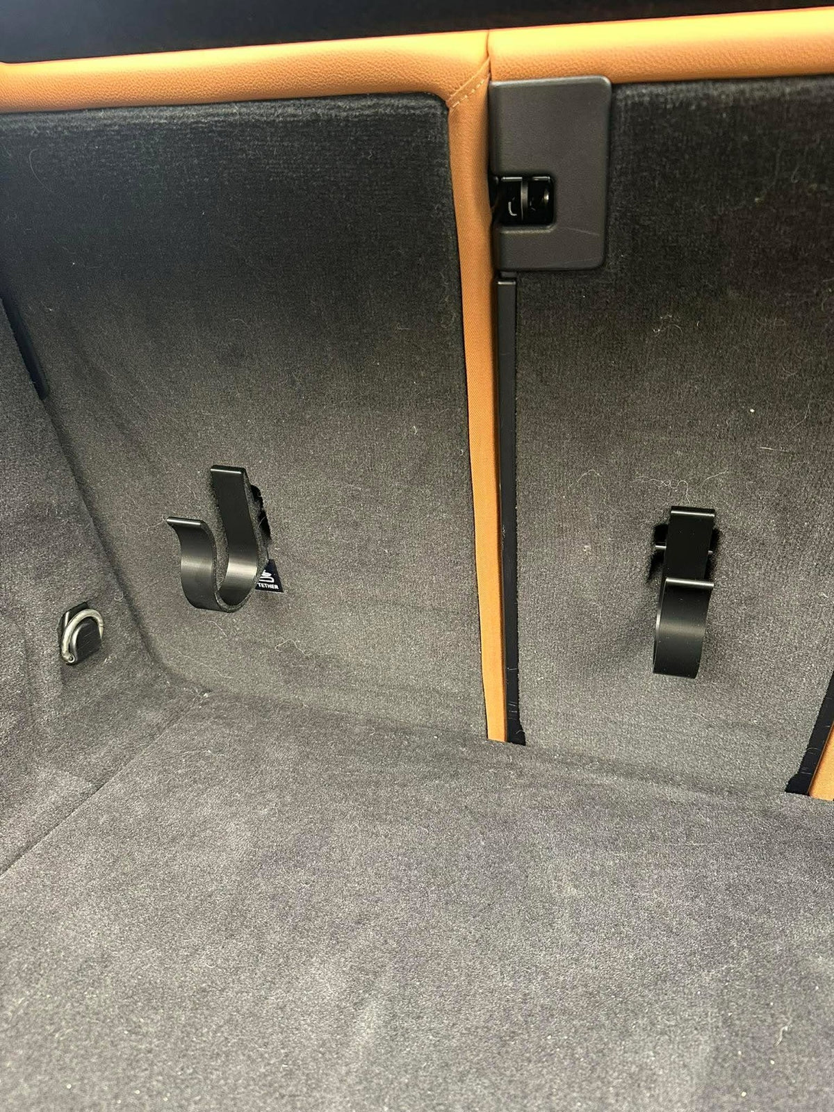2 paraplyholdere klikket fast på ISOFIX-beslaget på bagsiden af bagsædet i bagagerummet på en BMW i4